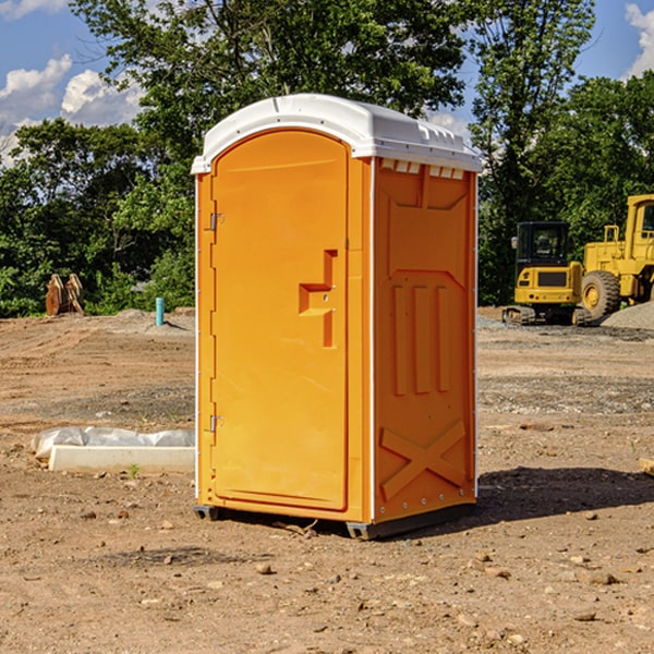 what is the cost difference between standard and deluxe portable toilet rentals in Rhodes